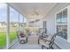 Relaxing screened porch with seating area, ceiling fan and backyard view at 360 Hillsborough Dr., Conway, SC 29526