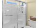 Clean bathroom with shower stall, white fixtures, and sliding glass door at 411A Ocean Blvd. S, Surfside Beach, SC 29575