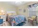 Bright bedroom with ocean-themed bedding, white furniture, and wicker chair at 411A Ocean Blvd. S, Surfside Beach, SC 29575