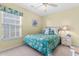 Cozy bedroom with teal bedding, white painted walls, and window with blinds at 411A Ocean Blvd. S, Surfside Beach, SC 29575