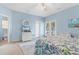 Second bedroom with white dresser, private balcony access, and ensuite bathroom at 411A Ocean Blvd. S, Surfside Beach, SC 29575