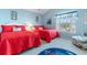 Third bedroom with two twin beds, red bedding, and cheerful decor at 411A Ocean Blvd. S, Surfside Beach, SC 29575