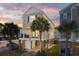 Two-story beach home with palm trees, balconies, and evening sky at 411A Ocean Blvd. S, Surfside Beach, SC 29575