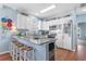Bright, beach-themed kitchen with white cabinets, granite countertops, and stainless steel appliances at 411A Ocean Blvd. S, Surfside Beach, SC 29575