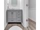 Gray bathroom vanity with marble countertop, modern fixtures, and wood-look flooring at 4355 Rivergate Ln. # E, Little River, SC 29566