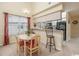 Dining area with table, chairs, breakfast bar, and view of the kitchen at 5050 Windsor Green Way # 304, Myrtle Beach, SC 29579