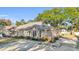 Tan house with dark shutters, a brick base, and a spacious driveway at 58 Pool Pl. # 73, Georgetown, SC 29440