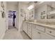 Double vanity bathroom with granite countertop and large mirror at 6061 Tramonto St., Myrtle Beach, SC 29577