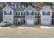 Three-unit townhome building, gray siding, two-car garages, and well-manicured landscaping at 608 Montenegro Way # E, Myrtle Beach, SC 29579