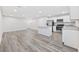 Open concept kitchen with island, stainless steel appliances, and light gray flooring at 608 Montenegro Way # E, Myrtle Beach, SC 29579