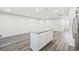 Open concept kitchen with island, stainless steel appliances, and light gray flooring at 608 Montenegro Way # E, Myrtle Beach, SC 29579