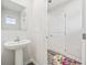 Small powder room with pedestal sink, mirror, and access to hallway at 608 Montenegro Way # E, Myrtle Beach, SC 29579