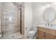 Bathroom with tiled shower, vanity, and a decorative oval mirror at 6105 Bolsena Place, Myrtle Beach, SC 29577