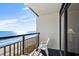 Balcony with chairs overlooking the sandy beach and ocean waves at 6804 N Ocean Blvd. # 1215, Myrtle Beach, SC 29572