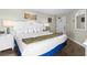 Bedroom with a king-size bed, white furniture, and coastal-themed decor at 6804 N Ocean Blvd. # 1215, Myrtle Beach, SC 29572