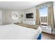 Bedroom featuring a king-size bed, white dresser, and a window view at 6804 N Ocean Blvd. # 1215, Myrtle Beach, SC 29572