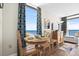 Dining area with table and chairs overlooking the ocean at 6804 N Ocean Blvd. # 1215, Myrtle Beach, SC 29572