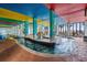 Indoor pool with a lazy river, waterslide, and colorful ceiling at 6804 N Ocean Blvd. # 1215, Myrtle Beach, SC 29572