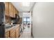 Kitchen with wooden cabinetry, black appliances, and a glimpse of the dining area at 6804 N Ocean Blvd. # 1215, Myrtle Beach, SC 29572