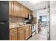 Compact kitchen with light wood cabinets, black appliances, and ocean view at 6804 N Ocean Blvd. # 1215, Myrtle Beach, SC 29572