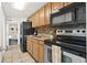 Compact kitchen with black appliances and wood cabinets at 6804 N Ocean Blvd. # 1215, Myrtle Beach, SC 29572