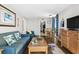 Living area with blue couch, dining table, and view to the kitchen at 6804 N Ocean Blvd. # 1215, Myrtle Beach, SC 29572