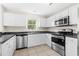 Kitchen with white cabinets, stainless steel appliances, and dark countertops at 809 Cherry Bark Ct., Myrtle Beach, SC 29579