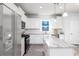 Modern kitchen with white cabinetry, stainless steel appliances, and a large island with granite countertops at 954 Laconic Dr., Myrtle Beach, SC 29588