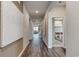 Hallway leading to various rooms, showcasing wood-look flooring and neutral decor at 986 Laconic Dr., Myrtle Beach, SC 29588