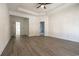 Spacious bedroom with tray ceiling, wood-look flooring, and ensuite bathroom access at 177 Splendor Circle, Murrells Inlet, SC 29576