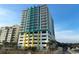 Modern high-rise building with colorful accents, parking garage, and beach access at 2301 S Ocean Blvd. # 1002, North Myrtle Beach, SC 29582