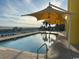 Inviting pool with yellow shade umbrellas and lounge chairs at 2301 S Ocean Blvd. # 1002, North Myrtle Beach, SC 29582