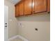 Laundry room with wooden cabinets, washer/dryer hookups, and tiled floor at 247 Macarthur Dr., Conway, SC 29527