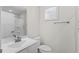 Simple bathroom with white vanity, toilet, and window with plantation shutters at 308 Golan Circle # C, Myrtle Beach, SC 29579