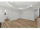 Open bedroom with ensuite bathroom access, wood-look floors, and recessed lighting at 308 Golan Circle # C, Myrtle Beach, SC 29579