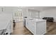 Open-concept kitchen with island, white cabinets, and view of living area at 308 Golan Circle # C, Myrtle Beach, SC 29579