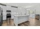 Kitchen with white cabinets, stainless steel appliances, an island, and a dining area at 308 Golan Circle # C, Myrtle Beach, SC 29579