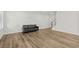 Living room featuring wood-look flooring, a black couch, and white walls at 308 Golan Circle # C, Myrtle Beach, SC 29579