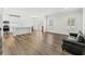 Open-concept living area with wood-look flooring, a black couch, and a view of the kitchen at 308 Golan Circle # C, Myrtle Beach, SC 29579