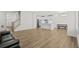 Spacious living room with wood-look floors and a black leather couch at 308 Golan Circle # C, Myrtle Beach, SC 29579