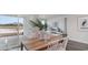 Dining area with a wooden table, white chairs, and sliding doors leading to a patio at 328 Glade Ct., Loris, SC 29569