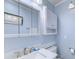 Light blue bathroom featuring a white vanity, mirror, and medicine cabinet at 415 Ocean Creek Dr. # 2373, Myrtle Beach, SC 29572