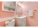 Peach colored bathroom with white vanity and fixtures at 415 Ocean Creek Dr. # 2373, Myrtle Beach, SC 29572