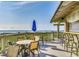 Beach bar with a blue umbrella, chairs and tables, and the ocean in the background at 415 Ocean Creek Dr. # 2373, Myrtle Beach, SC 29572