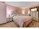 Cozy bedroom with coral walls, white furniture, and coastal decor at 415 Ocean Creek Dr. # 2373, Myrtle Beach, SC 29572