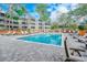Community pool with lounge chairs and surrounding trees at 415 Ocean Creek Dr. # 2373, Myrtle Beach, SC 29572