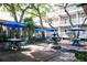 Outdoor courtyard with blue umbrellas, tables, chairs and a water fountain at 415 Ocean Creek Dr. # 2373, Myrtle Beach, SC 29572