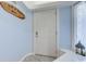 Entryway with a white door, light blue walls, and beach-themed decor at 415 Ocean Creek Dr. # 2373, Myrtle Beach, SC 29572