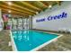 Large indoor swimming pool with high ceiling and Ocean Creek signage at 415 Ocean Creek Dr. # 2373, Myrtle Beach, SC 29572
