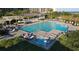 Large pool with lounge chairs, a hot tub, and people relaxing at Ocean Creek Plantation at 415 Ocean Creek Dr. # 2373, Myrtle Beach, SC 29572